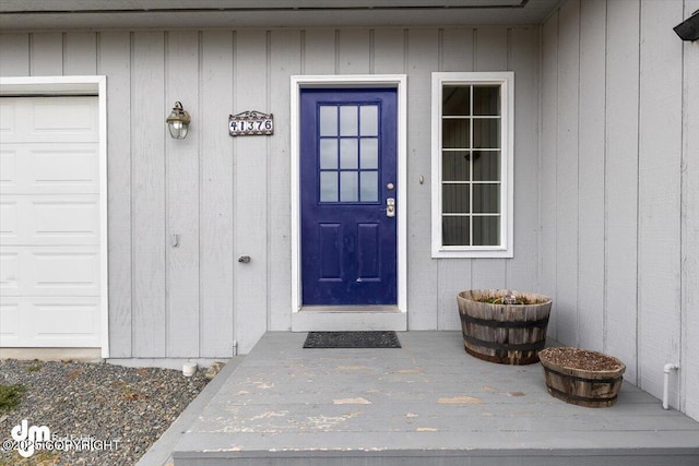 entrance to property featuring an attached garage
