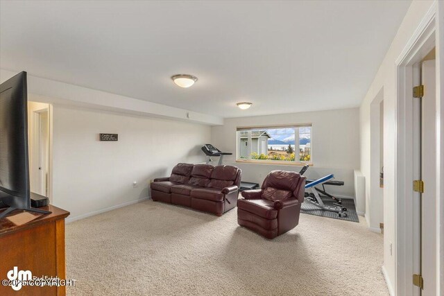 carpeted living room with baseboards