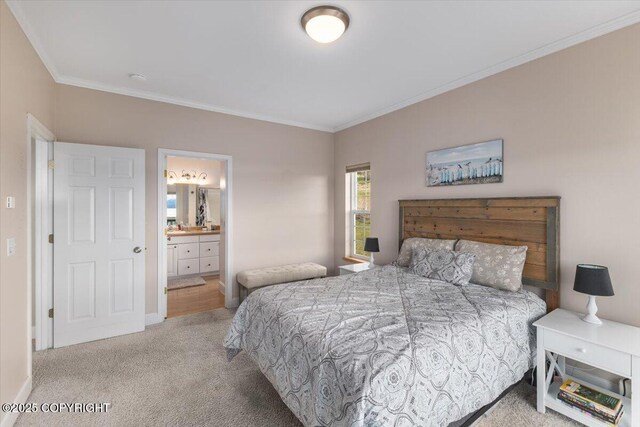 carpeted bedroom featuring crown molding and connected bathroom
