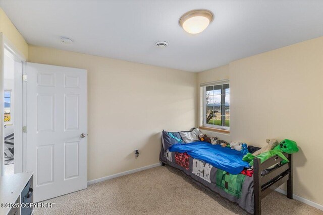 bedroom featuring carpet floors and baseboards