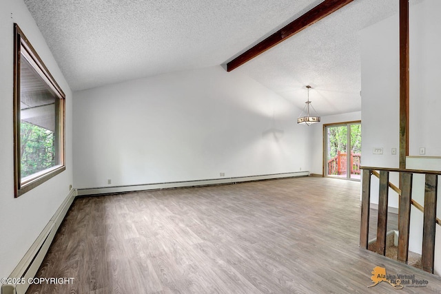 5900 E Liberty Ct, Wasilla, AK 99654 - empty room featuring wood finished floors, a textured ceiling, a baseboard radiator, a chandelier, and baseboards