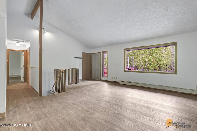 5900 E Liberty Ct, Wasilla, AK 99654 - spare room featuring wood finished floors, a textured ceiling, and a baseboard radiator