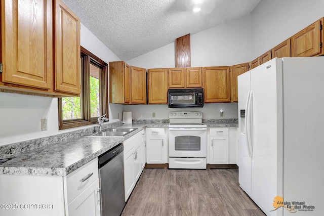 5900 E Liberty Ct, Wasilla, AK 99654 - kitchen featuring white appliances, a sink, a textured ceiling, high vaulted ceiling, and light wood-type flooring