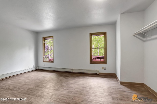5900 E Liberty Ct, Wasilla, AK 99654 - unfurnished room featuring healthy amount of natural light, wood finished floors, and baseboards