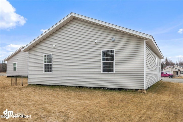 view of home's exterior with a yard