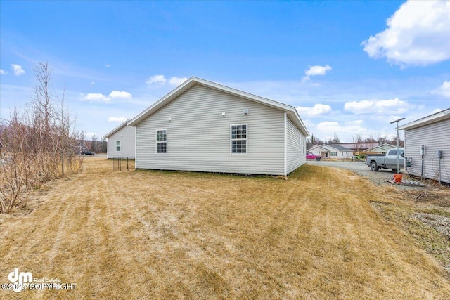 back of property featuring a yard