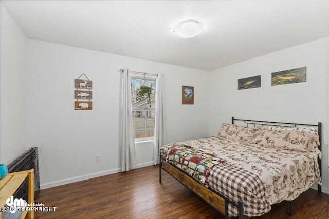 bedroom featuring baseboards and wood finished floors