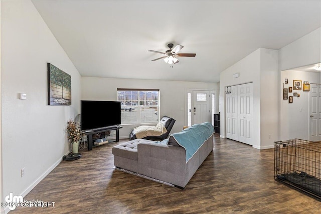 living area featuring baseboards, a ceiling fan, wood finished floors, and vaulted ceiling