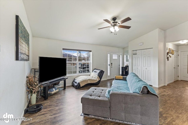 living room with a ceiling fan, baseboards, vaulted ceiling, and wood finished floors