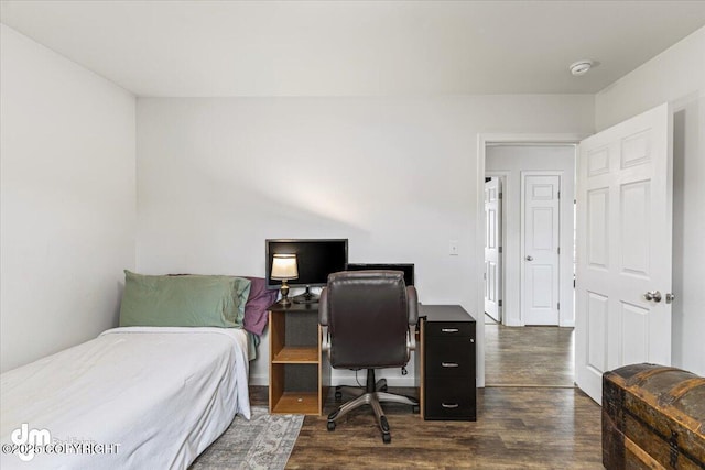 bedroom with dark wood finished floors