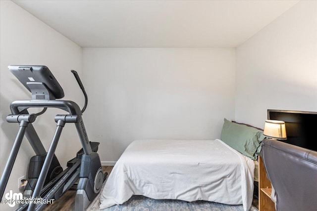 bedroom featuring baseboards and wood finished floors
