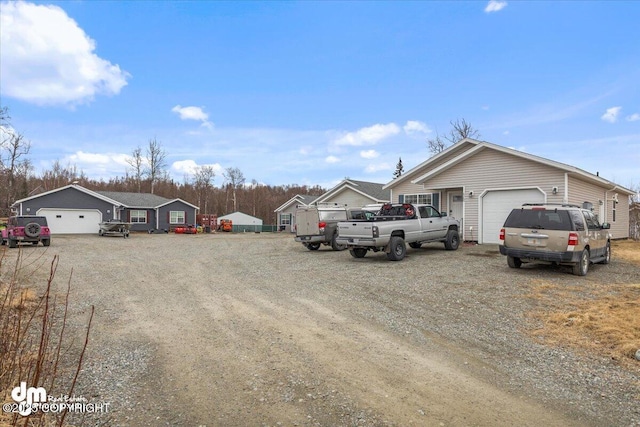 view of front of house featuring an attached garage and dirt driveway