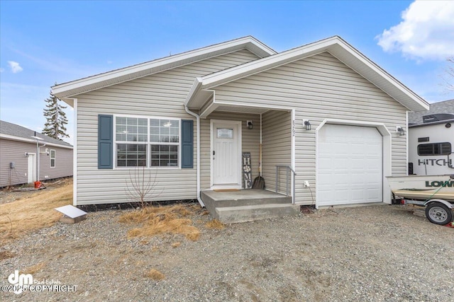 ranch-style house with a garage and dirt driveway