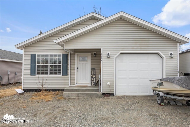 view of front facade featuring an attached garage and dirt driveway