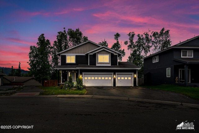 13050 Curry Ridge Cir, Eagle River, AK 99577 - traditional-style house with a garage, asphalt driveway, and board and batten siding