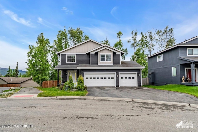 13050 Curry Ridge Cir, Eagle River, AK 99577 - traditional-style home with asphalt driveway, an attached garage, and board and batten siding
