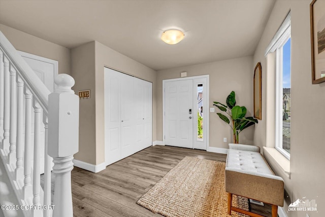 13050 Curry Ridge Cir, Eagle River, AK 99577 - foyer with wood finished floors, stairs, and baseboards