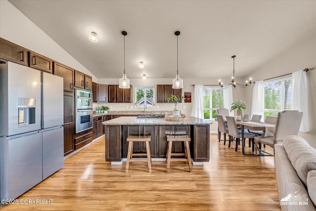 13050 Curry Ridge Cir, Eagle River, AK 99577 - kitchen with refrigerator with ice dispenser, lofted ceiling, light wood-style flooring, a chandelier, and a center island