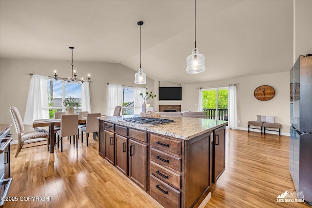 13050 Curry Ridge Cir, Eagle River, AK 99577 - kitchen with freestanding refrigerator, light wood-style floors, a chandelier, lofted ceiling, and open floor plan
