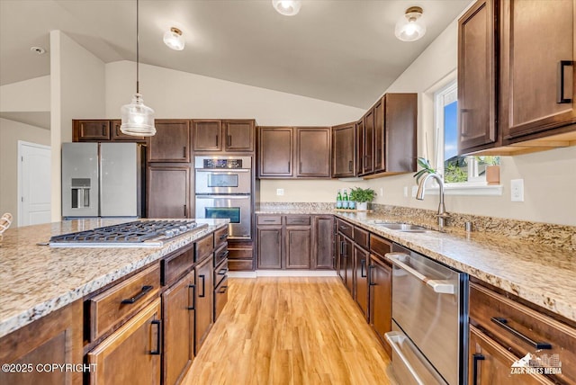 13050 Curry Ridge Cir, Eagle River, AK 99577 - kitchen featuring appliances with stainless steel finishes, lofted ceiling, a sink, pendant lighting, and light wood-style floors
