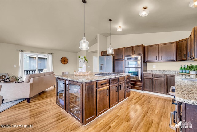 13050 Curry Ridge Cir, Eagle River, AK 99577 - kitchen featuring appliances with stainless steel finishes, lofted ceiling, light wood finished floors, and dark brown cabinets