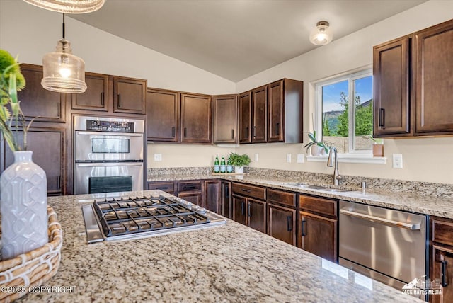 13050 Curry Ridge Cir, Eagle River, AK 99577 - kitchen featuring appliances with stainless steel finishes, a sink, vaulted ceiling, light stone counters, and dark brown cabinetry