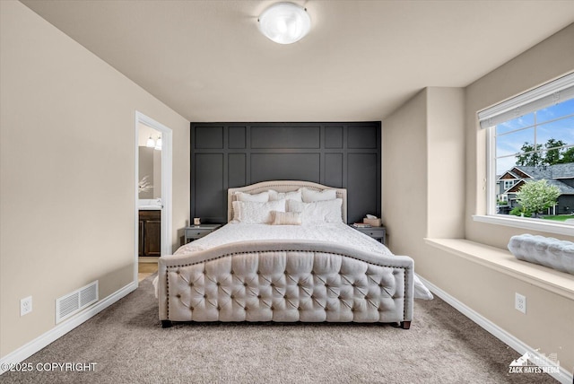 13050 Curry Ridge Cir, Eagle River, AK 99577 - bedroom with light colored carpet, baseboards, and connected bathroom