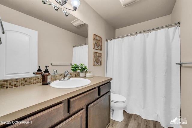 13050 Curry Ridge Cir, Eagle River, AK 99577 - bathroom featuring vanity, wood finished floors, toilet, and a shower with shower curtain