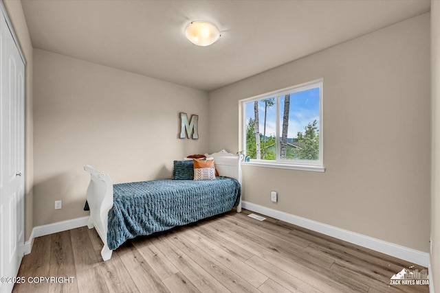 13050 Curry Ridge Cir, Eagle River, AK 99577 - bedroom with baseboards, light wood finished floors, and a closet