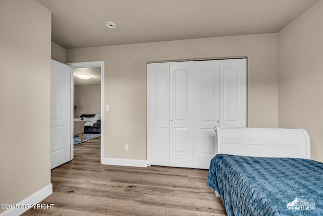13050 Curry Ridge Cir, Eagle River, AK 99577 - bedroom featuring wood finished floors, baseboards, and a closet