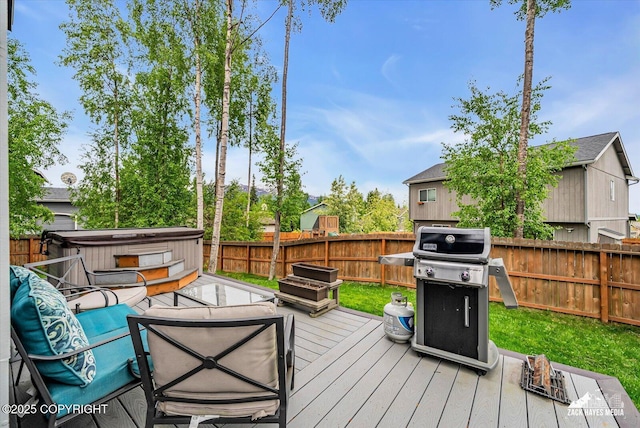 13050 Curry Ridge Cir, Eagle River, AK 99577 - deck with a hot tub, a fenced backyard, and a grill