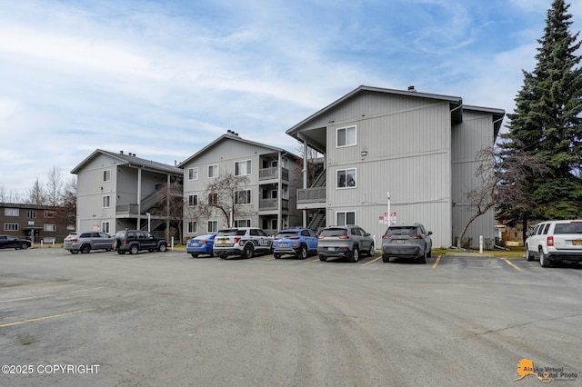 view of building exterior with uncovered parking