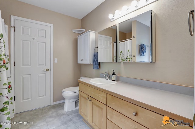 bathroom featuring toilet, tile patterned flooring, and vanity