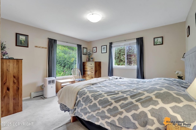 carpeted bedroom featuring baseboards and a baseboard radiator