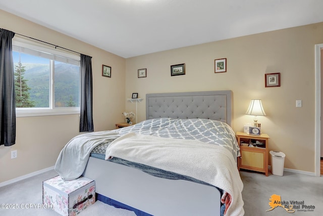 bedroom with baseboards and light carpet