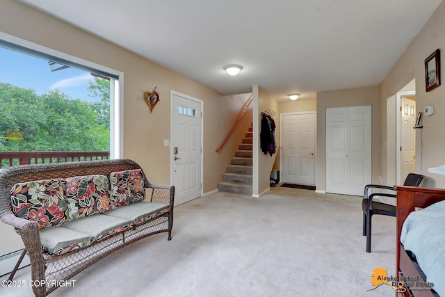 living area featuring stairway, baseboards, and light colored carpet