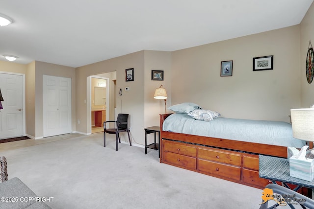 bedroom with baseboards, carpet, and ensuite bath