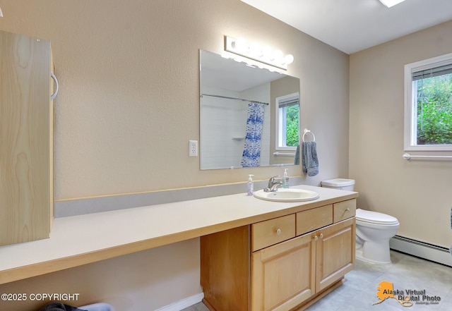 bathroom featuring vanity, a baseboard heating unit, toilet, and curtained shower