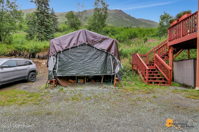 view of outbuilding with a mountain view and stairs