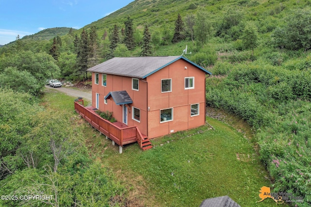 bird's eye view with a mountain view and a wooded view