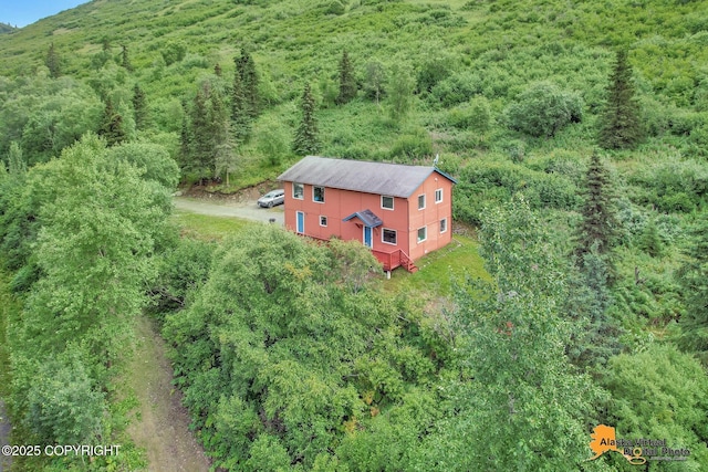 aerial view featuring a wooded view