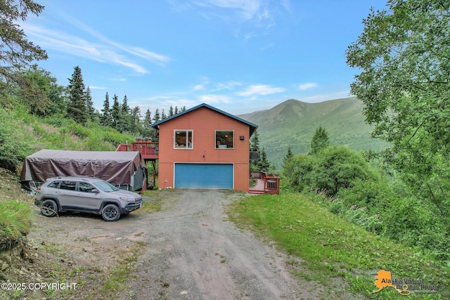 exterior space featuring a mountain view and driveway