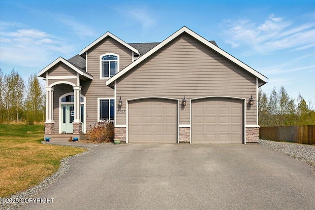 2153 S Withers Rd, Wasilla, AK 99654 - view of front of property featuring stone siding, driveway, an attached garage, and a front yard