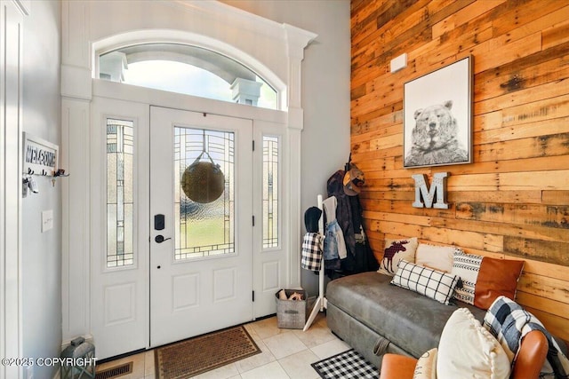 2153 S Withers Rd, Wasilla, AK 99654 - foyer entrance with wooden walls, light tile patterned flooring, and a high ceiling