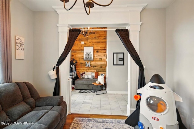 2153 S Withers Rd, Wasilla, AK 99654 - living area with a chandelier, wood walls, and decorative columns