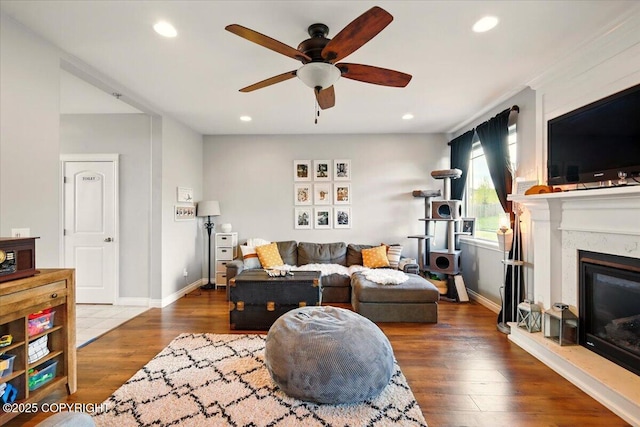 2153 S Withers Rd, Wasilla, AK 99654 - living room featuring a ceiling fan, wood finished floors, recessed lighting, and a glass covered fireplace