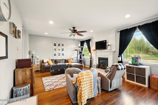 2153 S Withers Rd, Wasilla, AK 99654 - living room with plenty of natural light, wood finished floors, ceiling fan, a glass covered fireplace, and recessed lighting