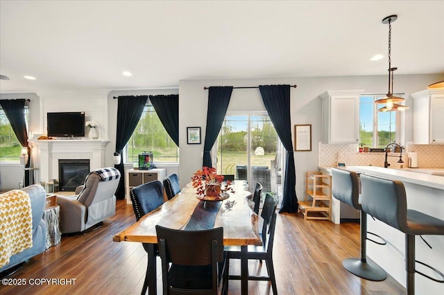 2153 S Withers Rd, Wasilla, AK 99654 - dining space with hardwood / wood-style floors, a glass covered fireplace, and recessed lighting