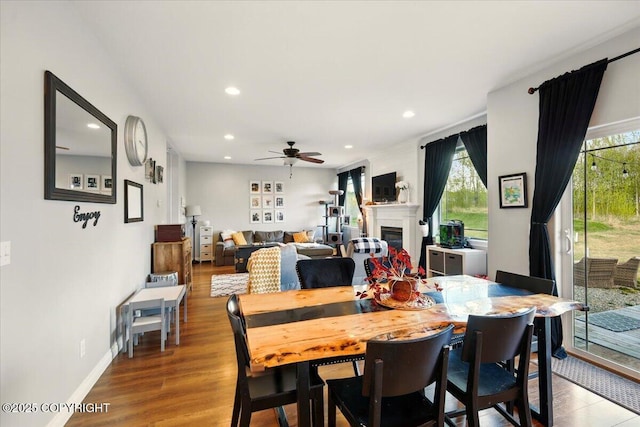 2153 S Withers Rd, Wasilla, AK 99654 - dining space featuring recessed lighting, ceiling fan, plenty of natural light, wood finished floors, and a fireplace