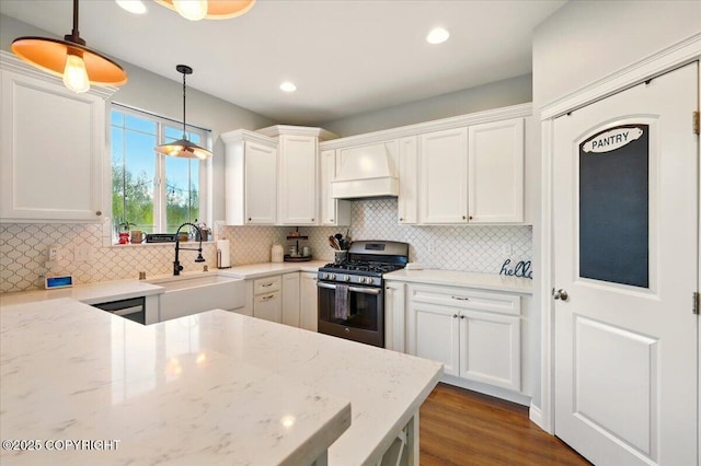 2153 S Withers Rd, Wasilla, AK 99654 - kitchen featuring stainless steel range with gas stovetop, white cabinetry, tasteful backsplash, hanging light fixtures, and recessed lighting